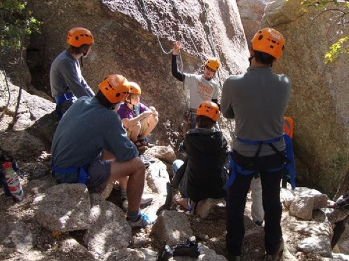 a group of people sitting on a rock