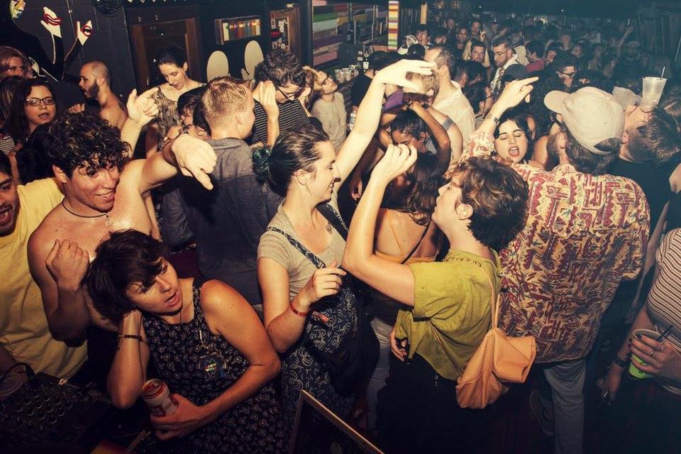 a group of people standing in front of a crowd posing for the camera