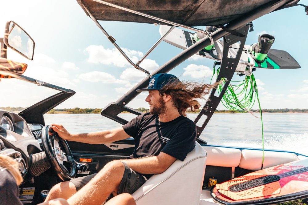 a person sitting in a boat on a body of water